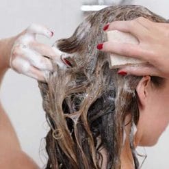 girl shampooing hair with shampoo bar